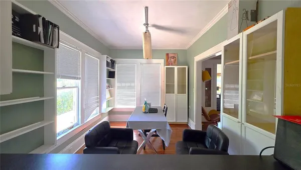a living room with furniture window and wooden floor
