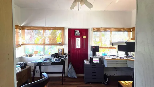 a view of a workspace with furniture and a window