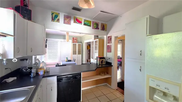 a kitchen with granite countertop a sink dishwasher stove and refrigerator with wooden floor