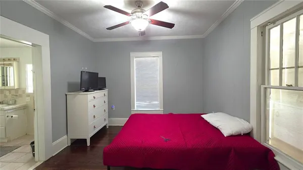 a bedroom with a bed and a window