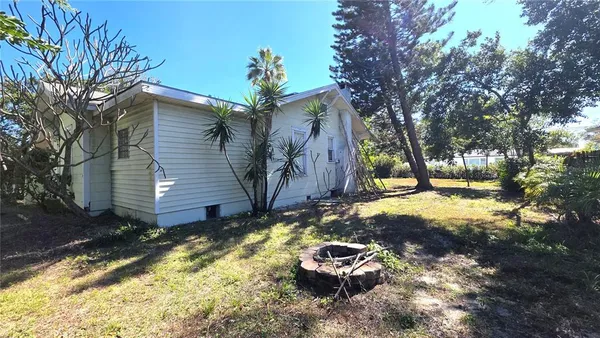 a backyard of a house with yard and outdoor seating