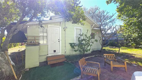 a view of a patio with table and chairs and potted plants