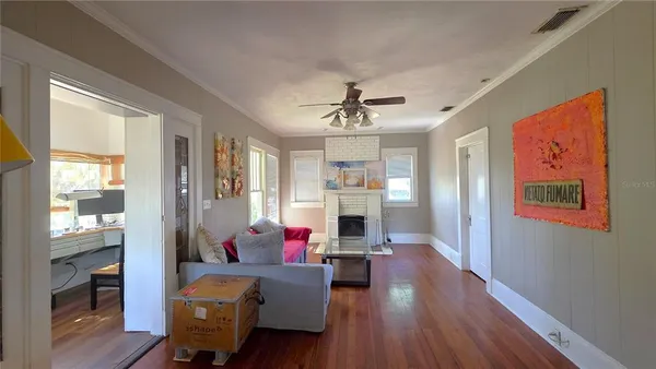 a living room with furniture and kitchen view
