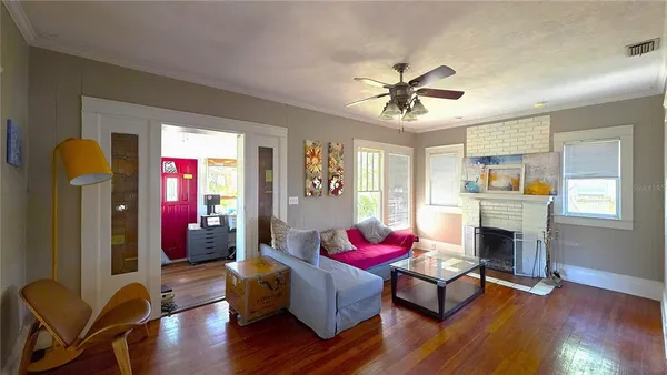 a living room with furniture fireplace and window