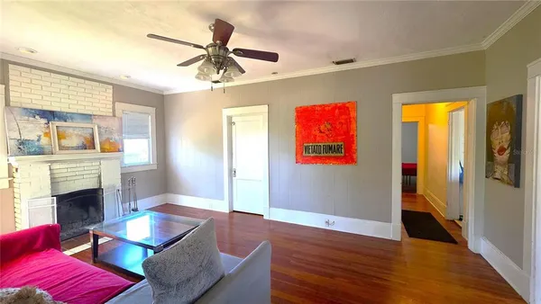 a living room with furniture fireplace and a window
