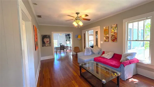 a living room with furniture and wooden floor
