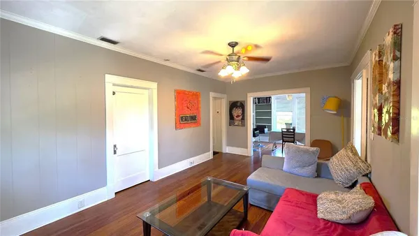 a living room with furniture and wooden floor