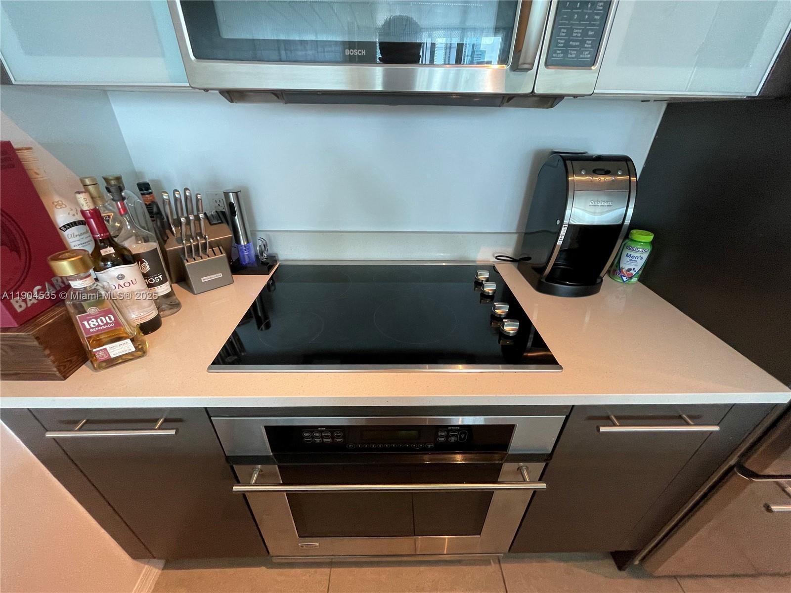 55 Southeast 6th Street, Unit 2104 Miami, FL 33131 - Photo 11 of 11 a close up of a stove top oven sitting inside of a kitchen