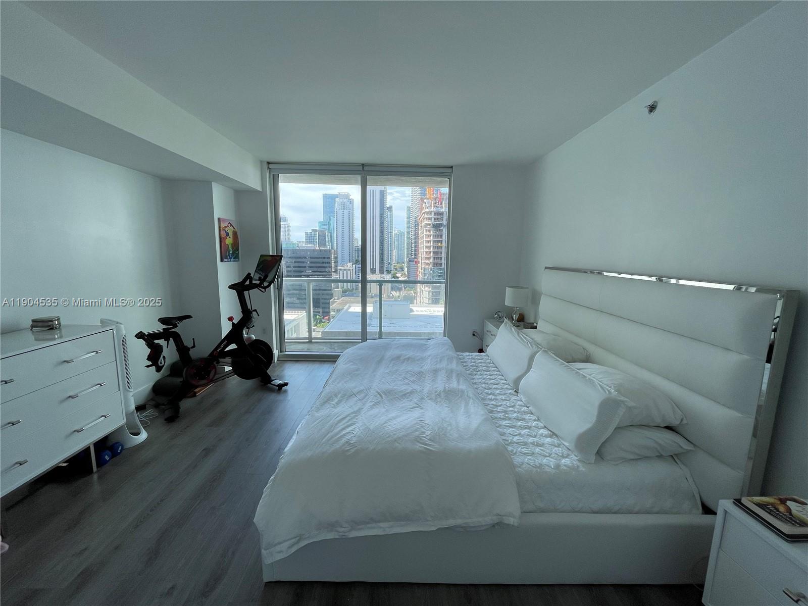 55 Southeast 6th Street, Unit 2104 Miami, FL 33131 - Photo 4 of 11 a bed room with a bed and furniture