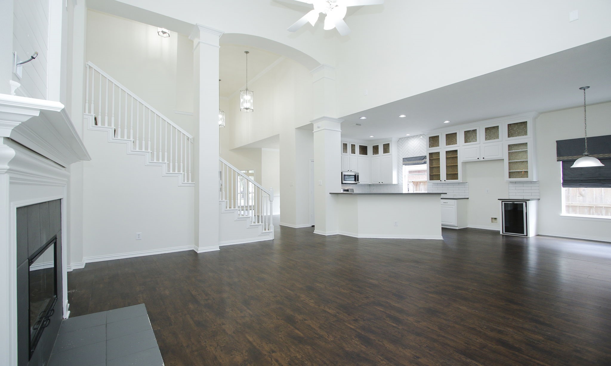 1210 Berwick Manor Court Spring, TX 77379 - Photo 19 of 50 a view of an empty room with wooden floor and a kitchen