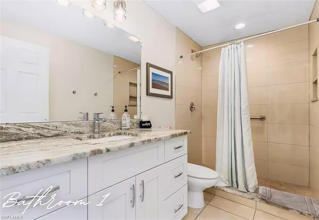3024 Estey Avenue Naples, FL 34104 - Photo 11 of 19 a bathroom with a granite countertop sink toilet and shower