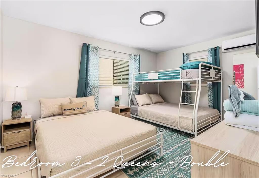 3024 Estey Avenue Naples, FL 34104 - Photo 14 of 19 a bedroom with two beds and windows