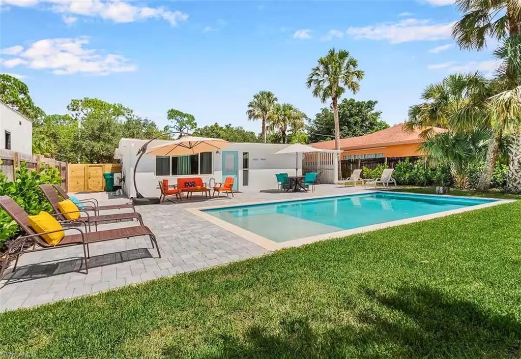 3024 Estey Avenue Naples, FL 34104 - Photo 16 of 19 a view of an house with swimming pool garden and patio