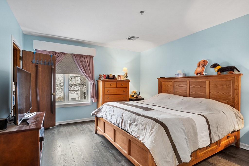 5 Tsienneto Road, Unit 198 Derry, NH 03038 - Photo 14 of 21 a bedroom with a bed and a dresser next to a window