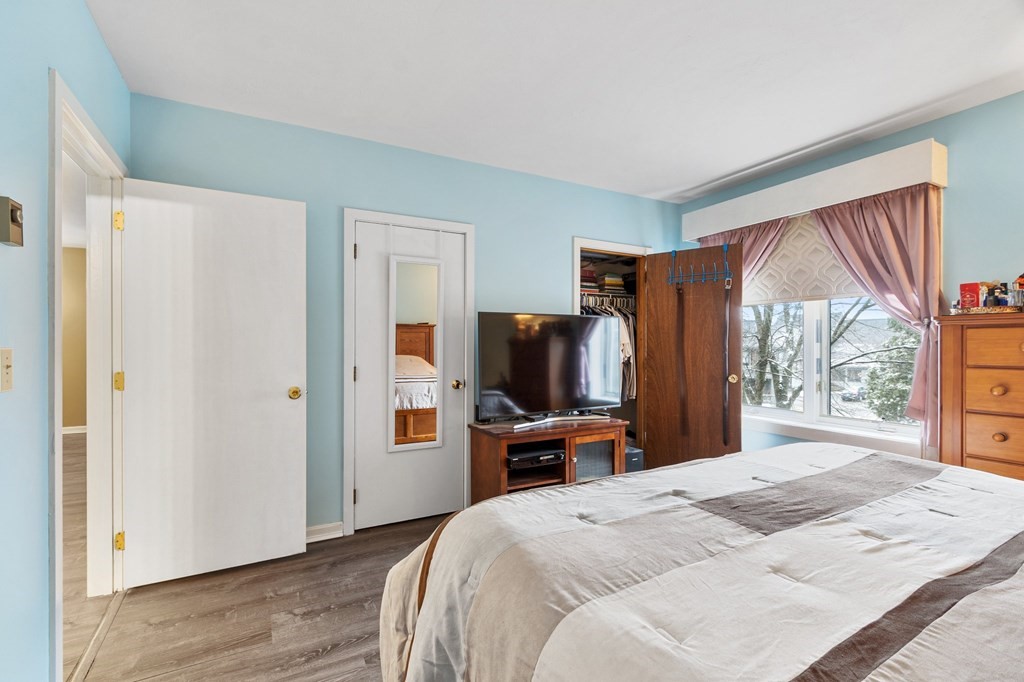 5 Tsienneto Road, Unit 198 Derry, NH 03038 - Photo 15 of 21 a bedroom with a bed and a flat screen tv