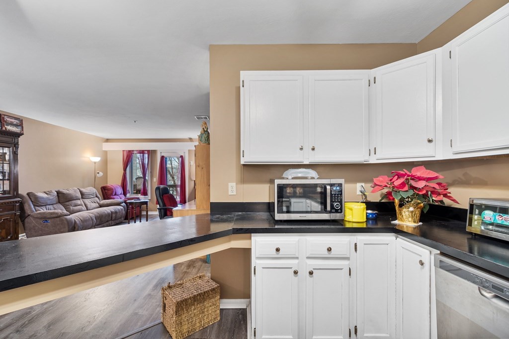 5 Tsienneto Road, Unit 198 Derry, NH 03038 - Photo 8 of 21 a kitchen with a sink cabinets and window