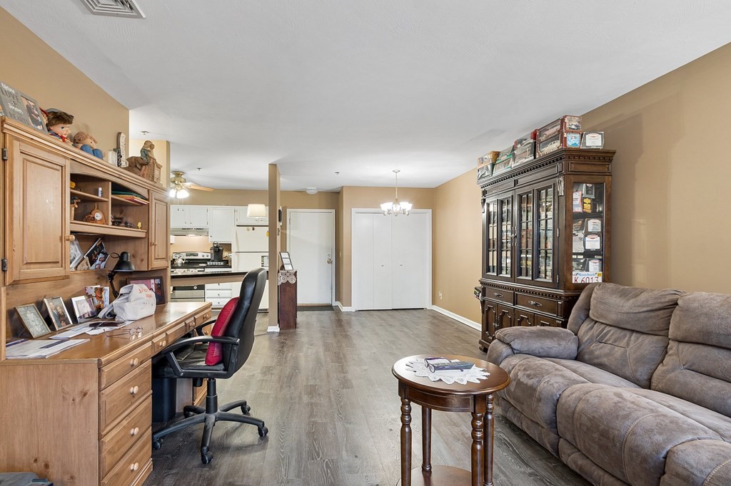 5 Tsienneto Road, Unit 198 Derry, NH 03038 - Photo 10 of 21 a living room with furniture a flat screen tv and a table