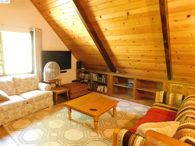 a living room with a couch and wooden floor