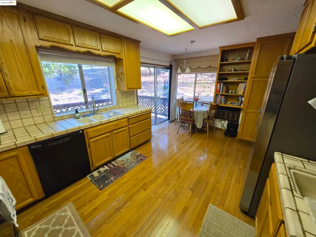 a kitchen with stainless steel appliances kitchen island granite countertop a stove and a refrigerator