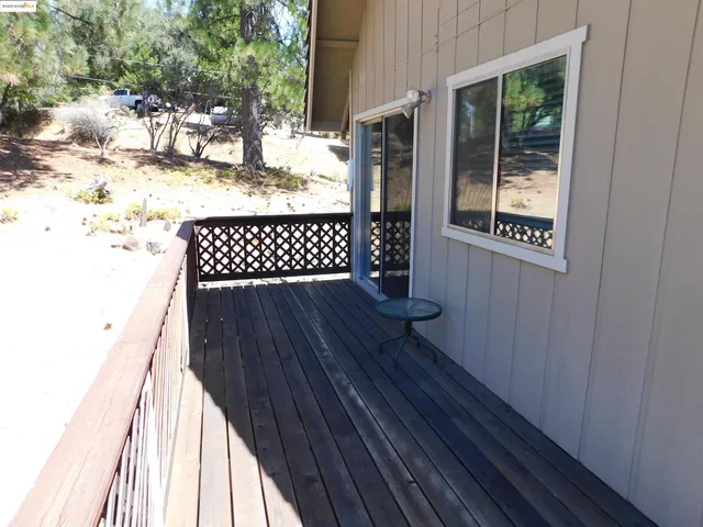 a view of balcony with wooden floor and fence