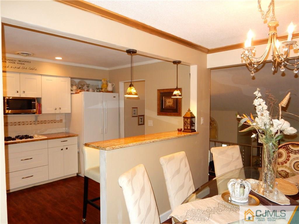 18 Villanova Road Old Bridge, NJ 08859 - Photo 9 of 25 a kitchen with stainless steel appliances kitchen island granite countertop a refrigerator and a sink