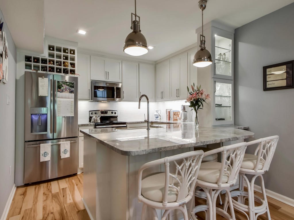 The kitchen which was recently renovated with quartzite countertops, new appliances, and new custom cabinetry.