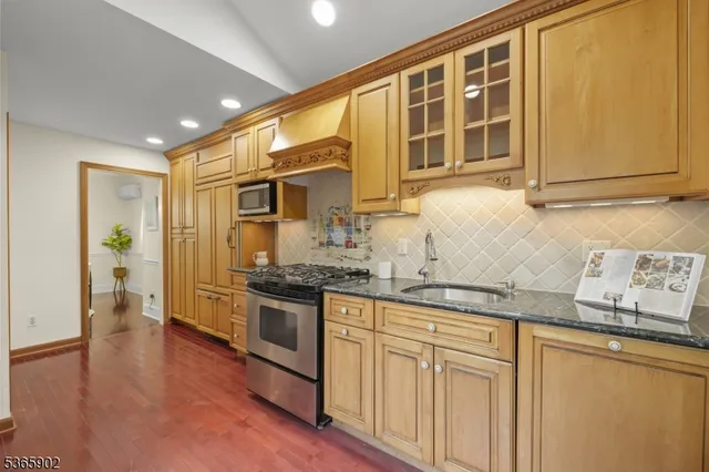 a kitchen with stainless steel appliances granite countertop a stove and a sink