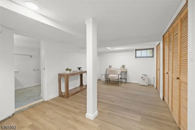 a view of a room with wooden floor and furniture