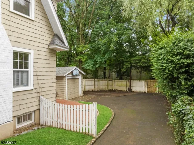 a view of a house with a yard garage and sitting area