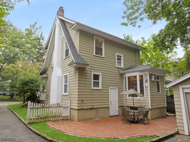 an aerial view of a residential house with a garden and plants