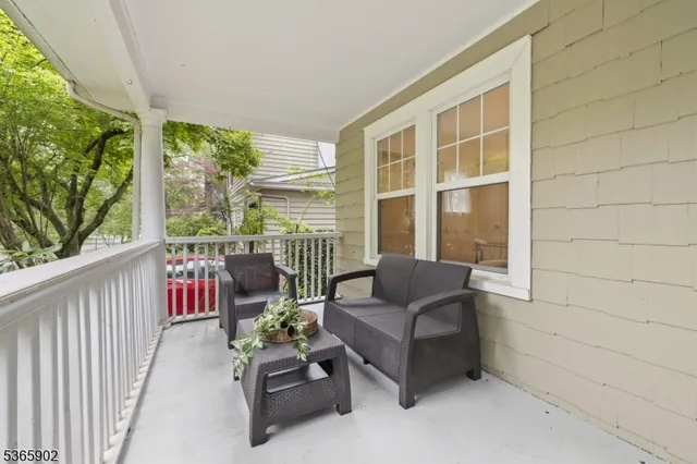 a balcony with furniture and garden view