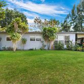 a view of a house with backyard and garden