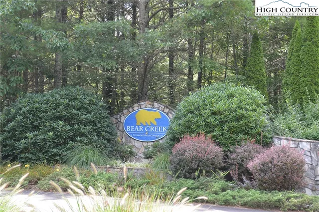a view of a table and chairs in a garden