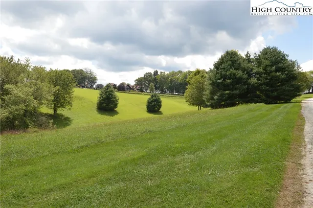 a swimming pool with trees in the background