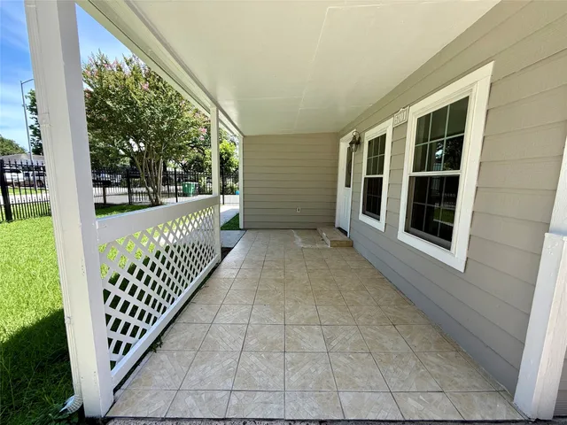 a view of a porch with wooden floor and fence
