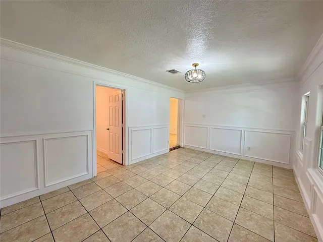 a kitchen with granite countertop white cabinets and stainless steel appliances