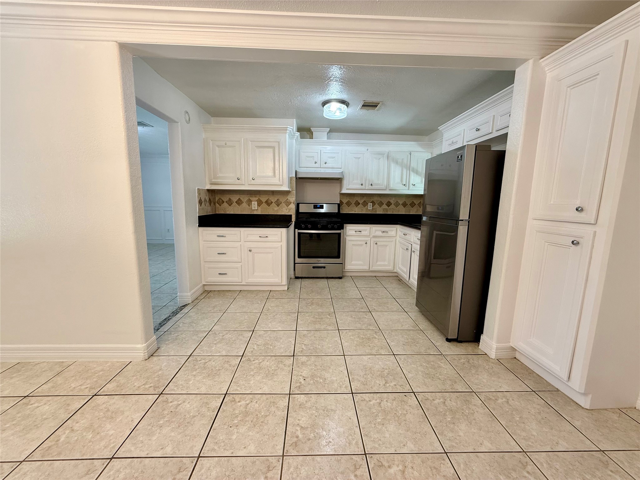 5701 Luna Street Houston, TX 77076 - Photo 25 of 50 a kitchen with stainless steel appliances a refrigerator and a counter top