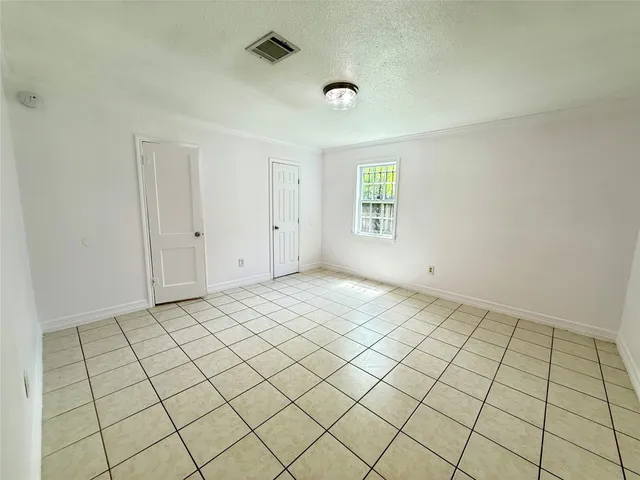 a view of an empty room and wooden shelves