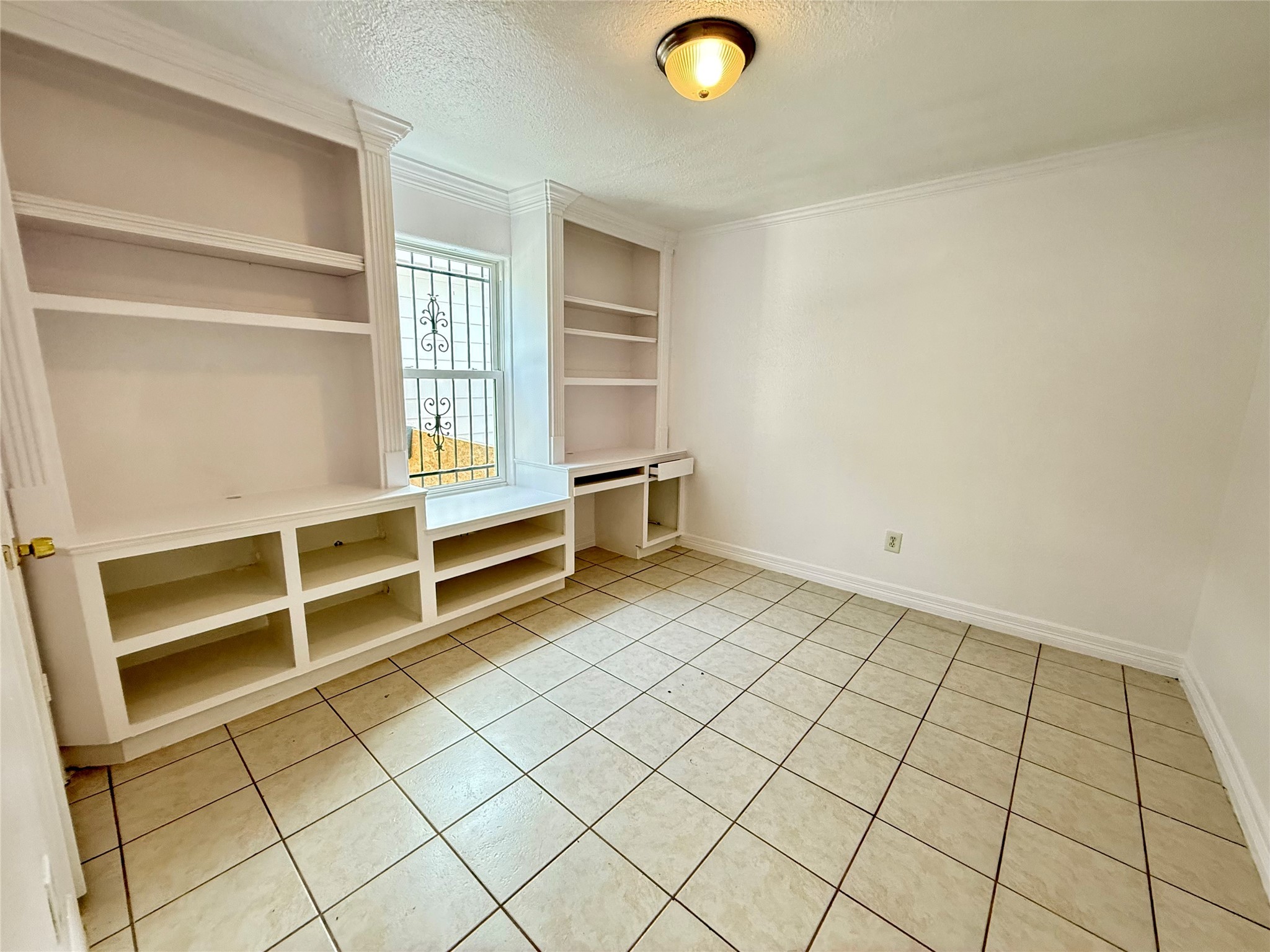 5701 Luna Street Houston, TX 77076 - Photo 35 of 50 a view of an empty room and wooden shelves