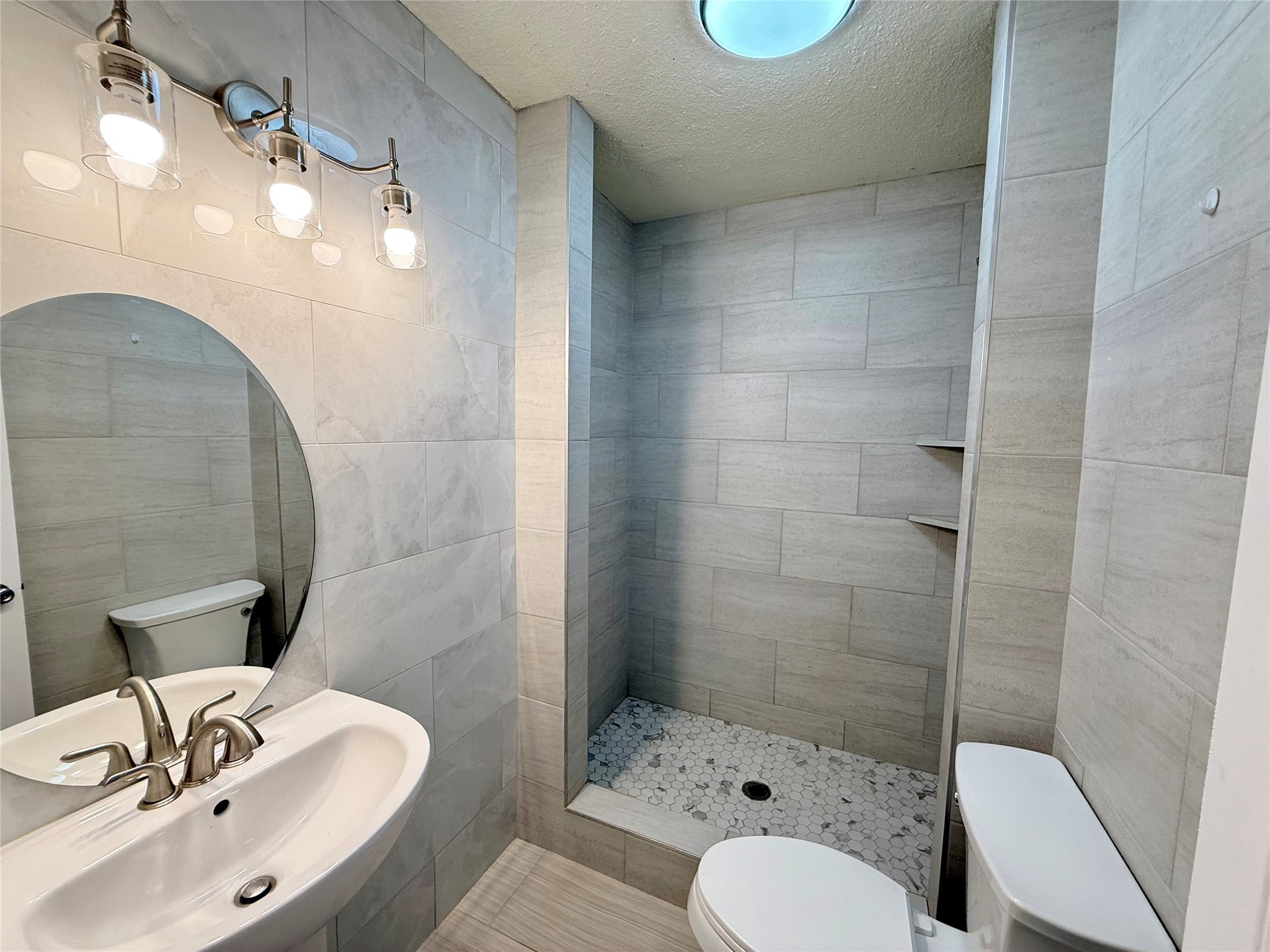 5701 Luna Street Houston, TX 77076 - Photo 39 of 50 a bathroom with a sink toilet and shower