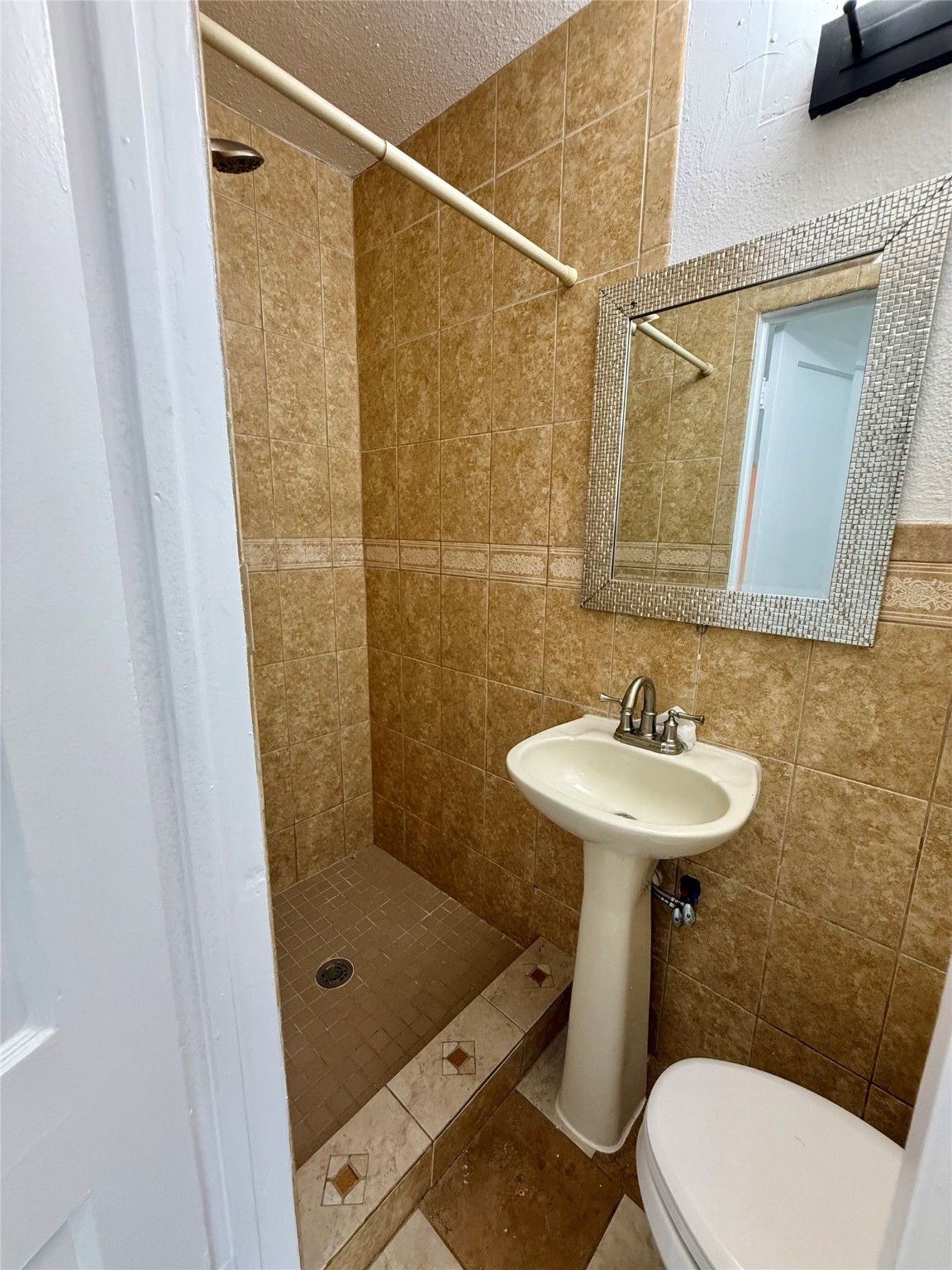 5701 Luna Street Houston, TX 77076 - Photo 41 of 50 a bathroom with a sink a toilet and shower
