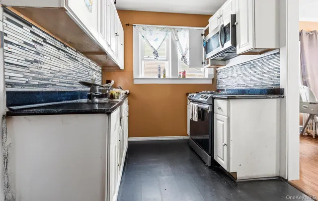 a utility room with a stove and a window
