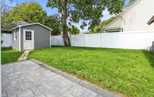 a view of backyard with a garden and entertaining space