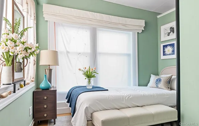a bedroom with a bed potted plant and a window
