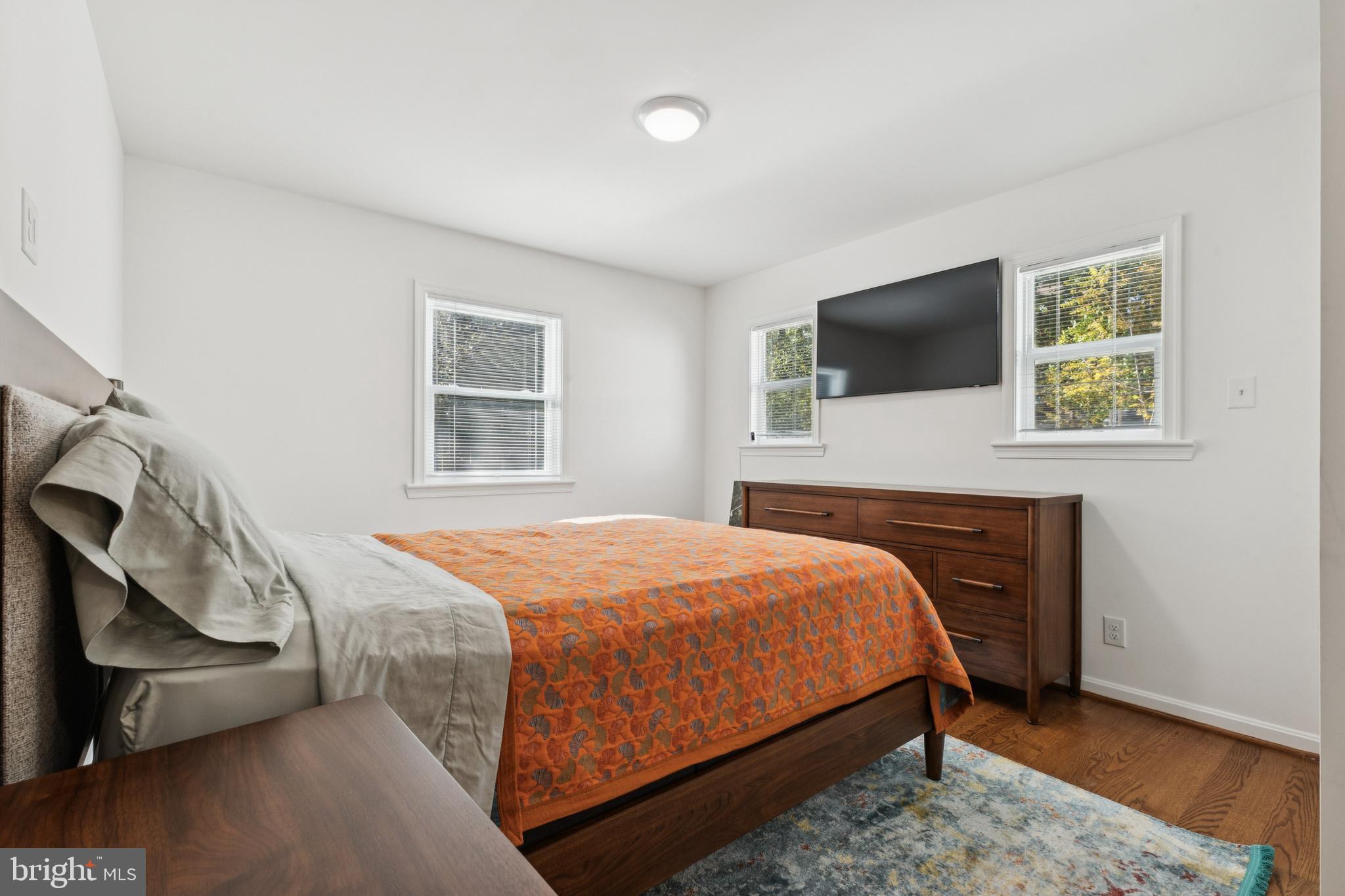 4146 Addison Road Fairfax, VA 22030 - Photo 16 of 33 a bedroom with a bed a flat screen tv and dresser