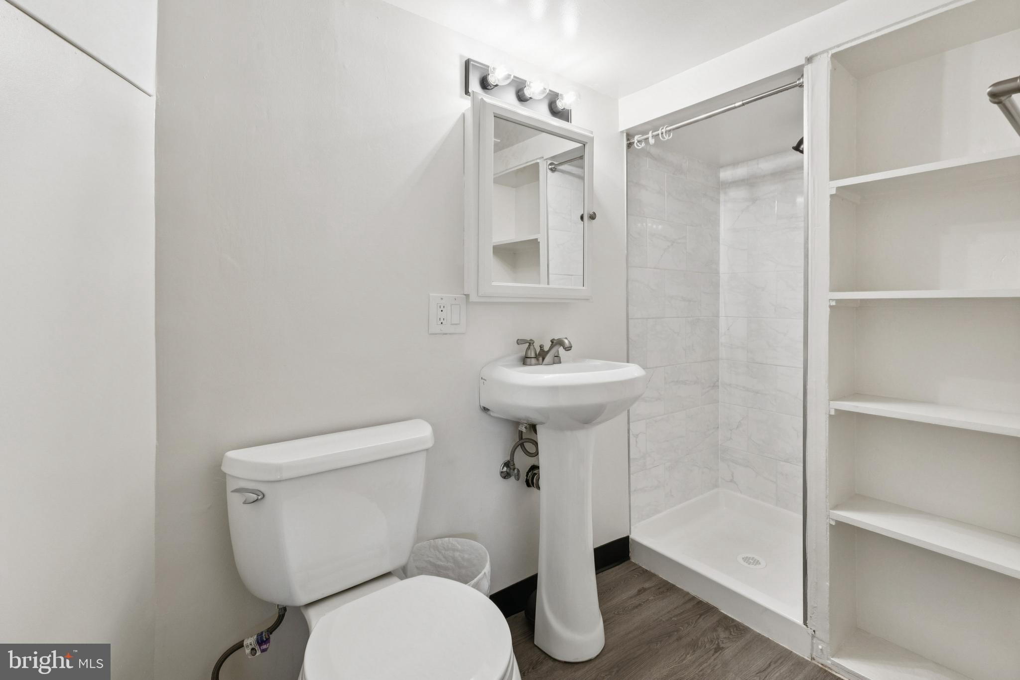 4146 Addison Road Fairfax, VA 22030 - Photo 24 of 33 a white toilet sitting next to a bathroom sink