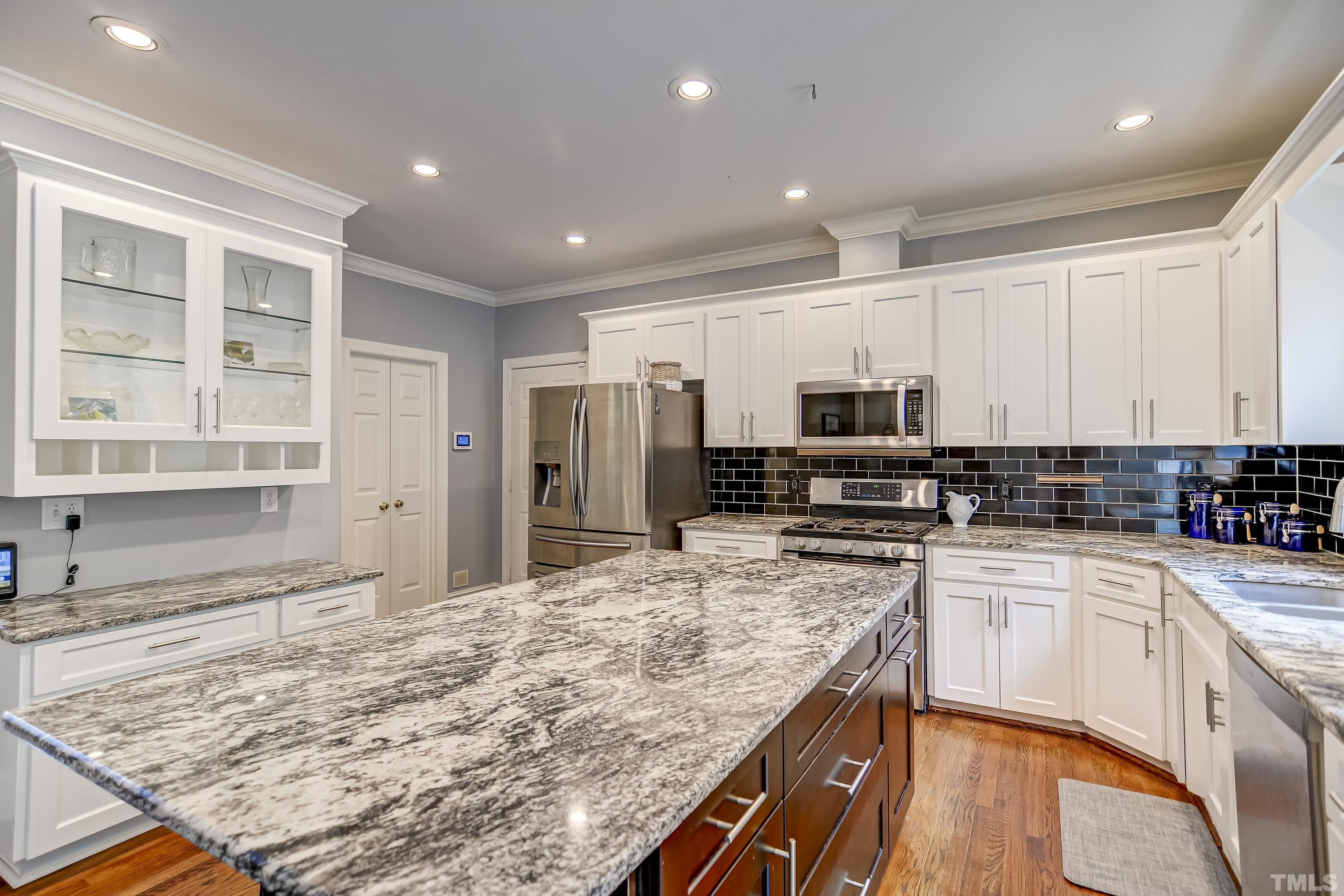 1309 Wescott Drive Raleigh, NC 27614 - Photo 11 of 32 a kitchen with stainless steel appliances granite countertop a sink stove and refrigerator