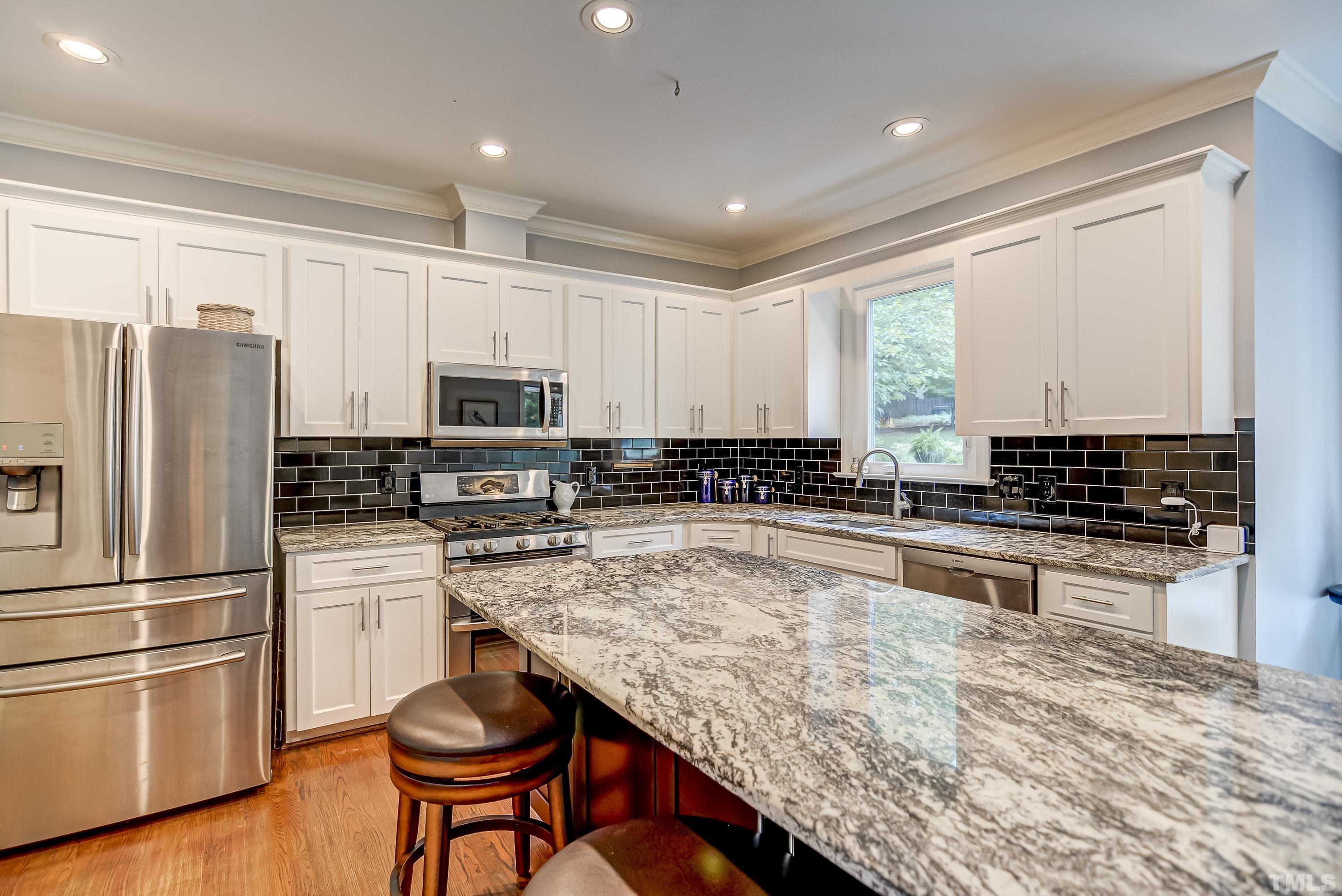 1309 Wescott Drive Raleigh, NC 27614 - Photo 12 of 32 a kitchen with stainless steel appliances granite countertop a stove refrigerator sink and microwave
