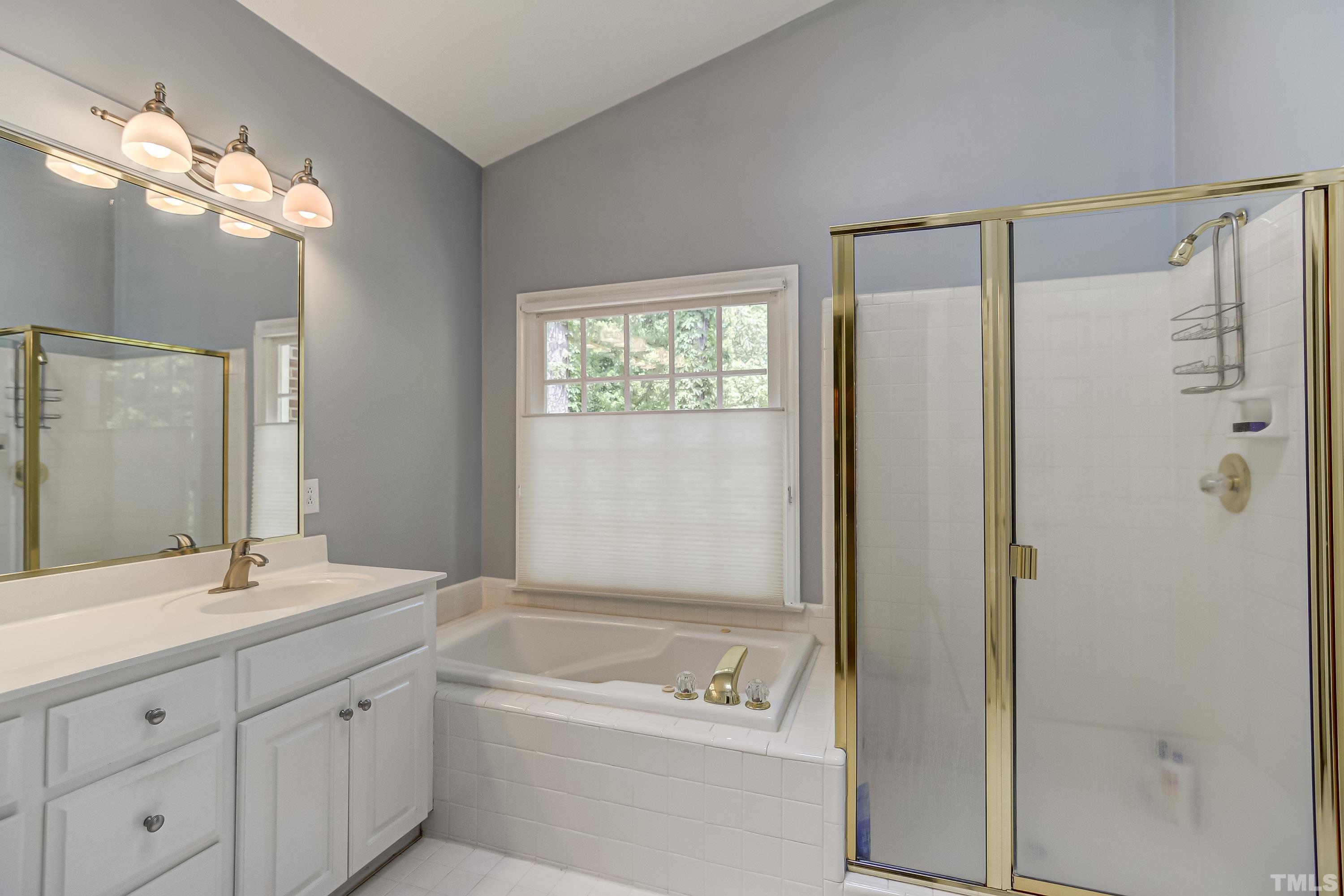 1309 Wescott Drive Raleigh, NC 27614 - Photo 18 of 32 a bathroom with a tub a sink shower and mirror