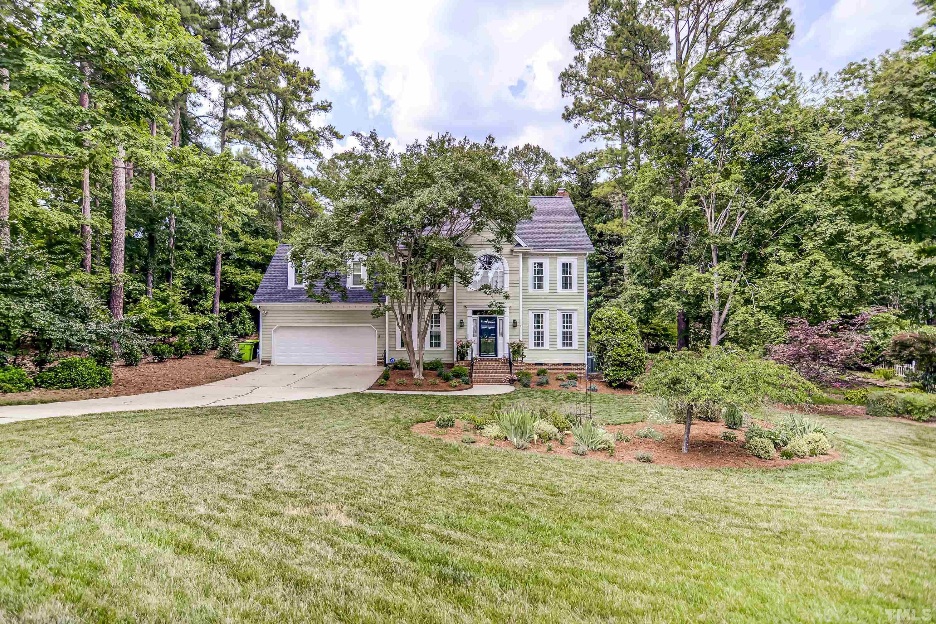 1309 Wescott Drive Raleigh, NC 27614 - Photo 2 of 32 a front view of a house with a yard and trees